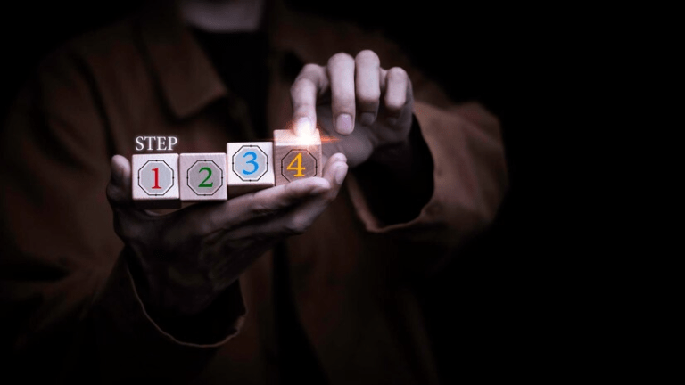 A person holding a stack of dice