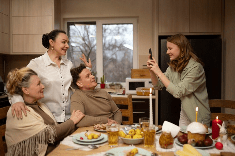 A person taking a picture of a group of people around a table