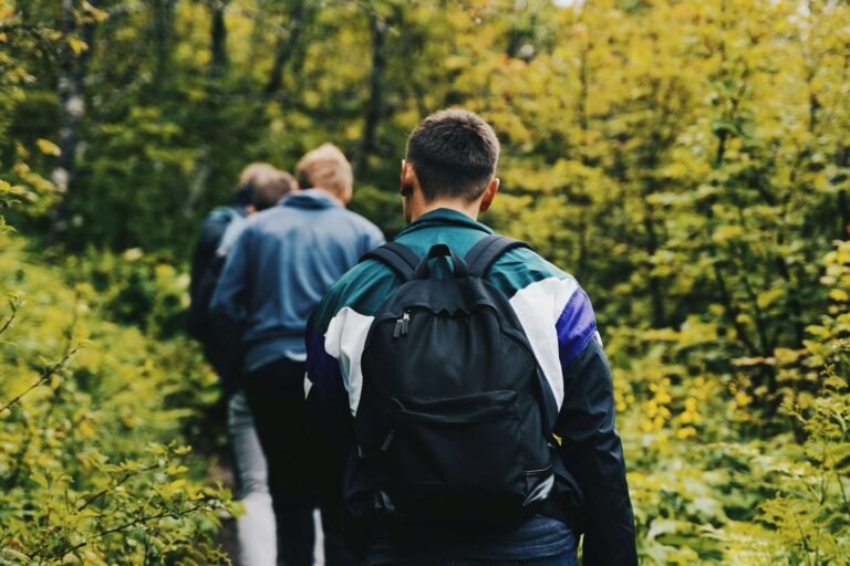 Group of men supporting each other during a Men’s Mental Health Month awareness event outdoors