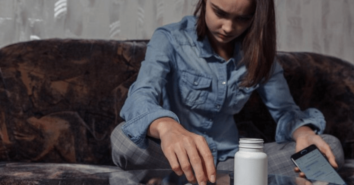 Person struggling with signs of addiction, showing emotional distress and warning signs of addiction.