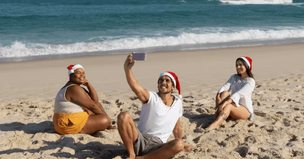 A group of people on a beach taking a selfie