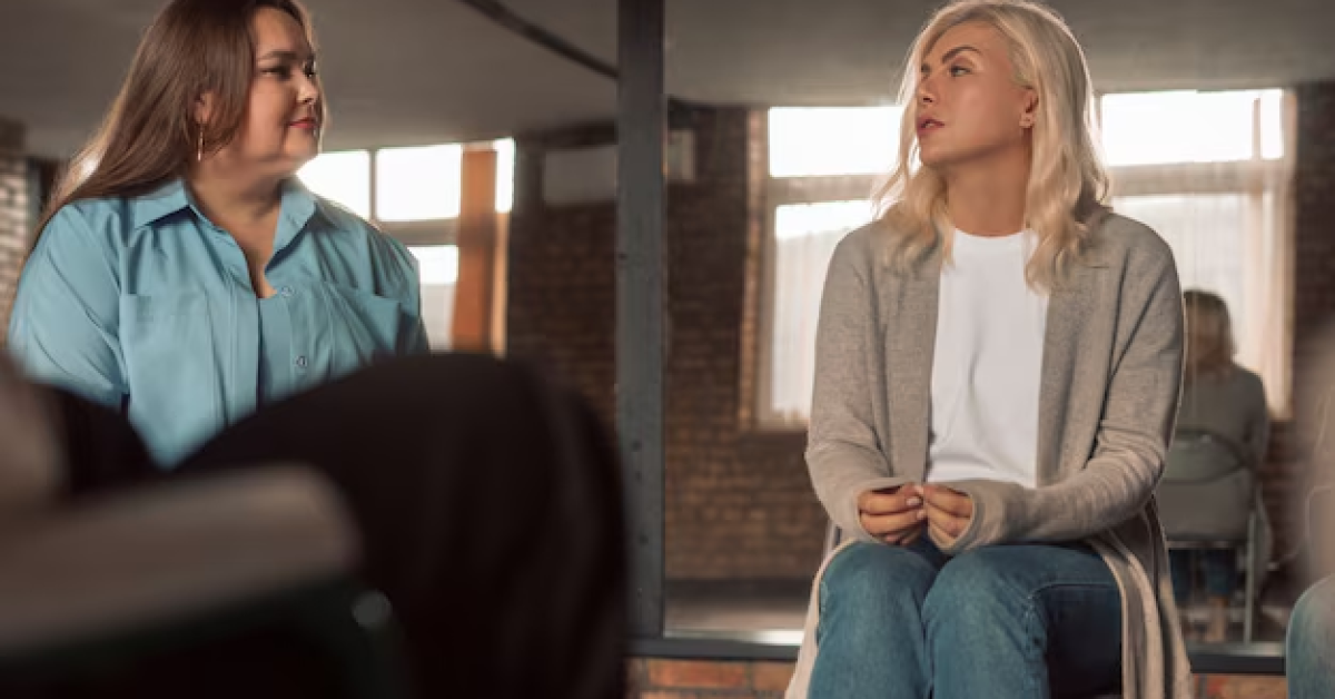 A person in a support group discussing assertiveness training techniques for recovery.