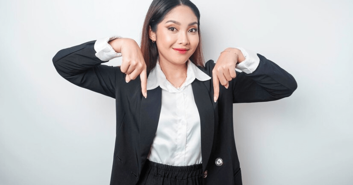 A person pointing down with her fingers