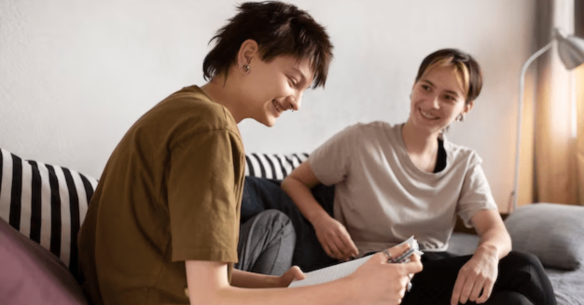 A young person and person sitting on a couch