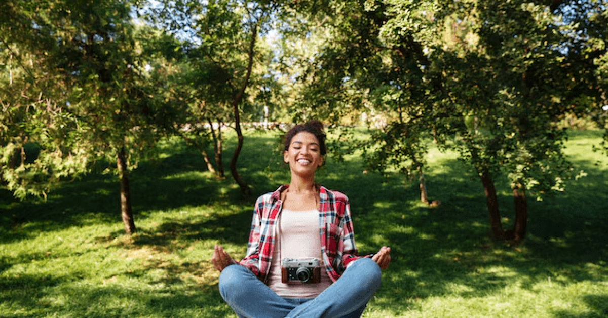 Person practicing mindfulness meditation outdoors for inner calm and focus.