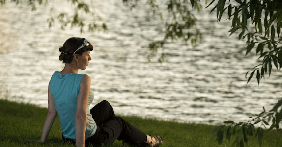 Person reflecting on overcoming negative self-talk with self improvement tips.