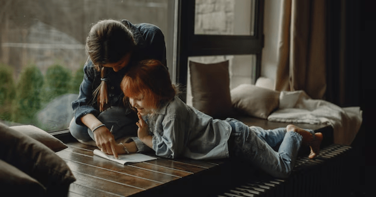 A parent and child laughing together while reading a book at home, highlighting positive parenting and the importance of positive parenting.