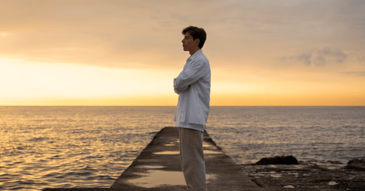 A person standing on a scenic path, symbolizing a fresh start and the journey of addiction recovery after rehab