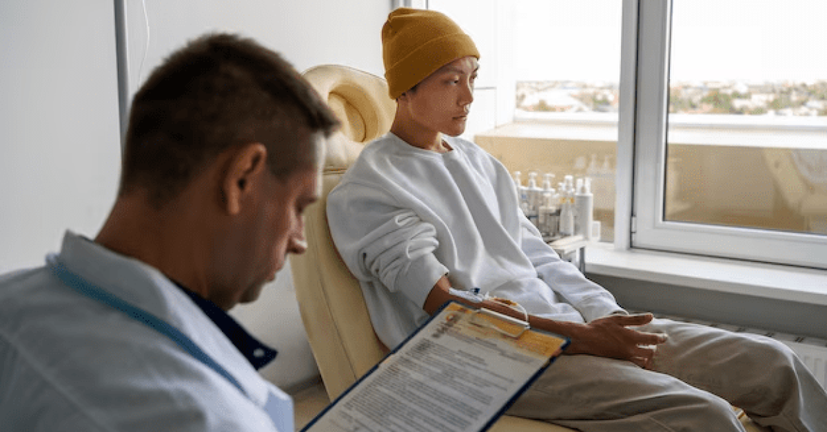 The Significance of Intensive Outpatient Treatment A person wearing white sleeves and a yellow beanie sitting in a chair with a specialist holding a clipboard