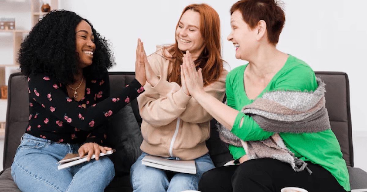 Women in addiction recovery supporting each other during a group session, promoting empowerment and specialized care.