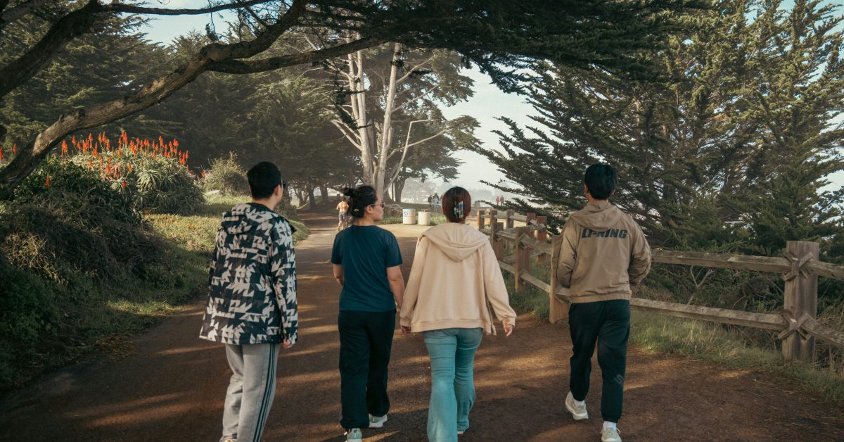 Group of people walking outdoors as part of a recovery program, showing the benefits of exercise in addiction recovery