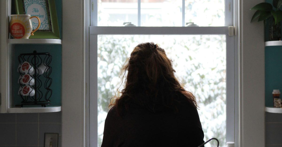Person practicing mindfulness breathing to cope with cravings during addiction recovery