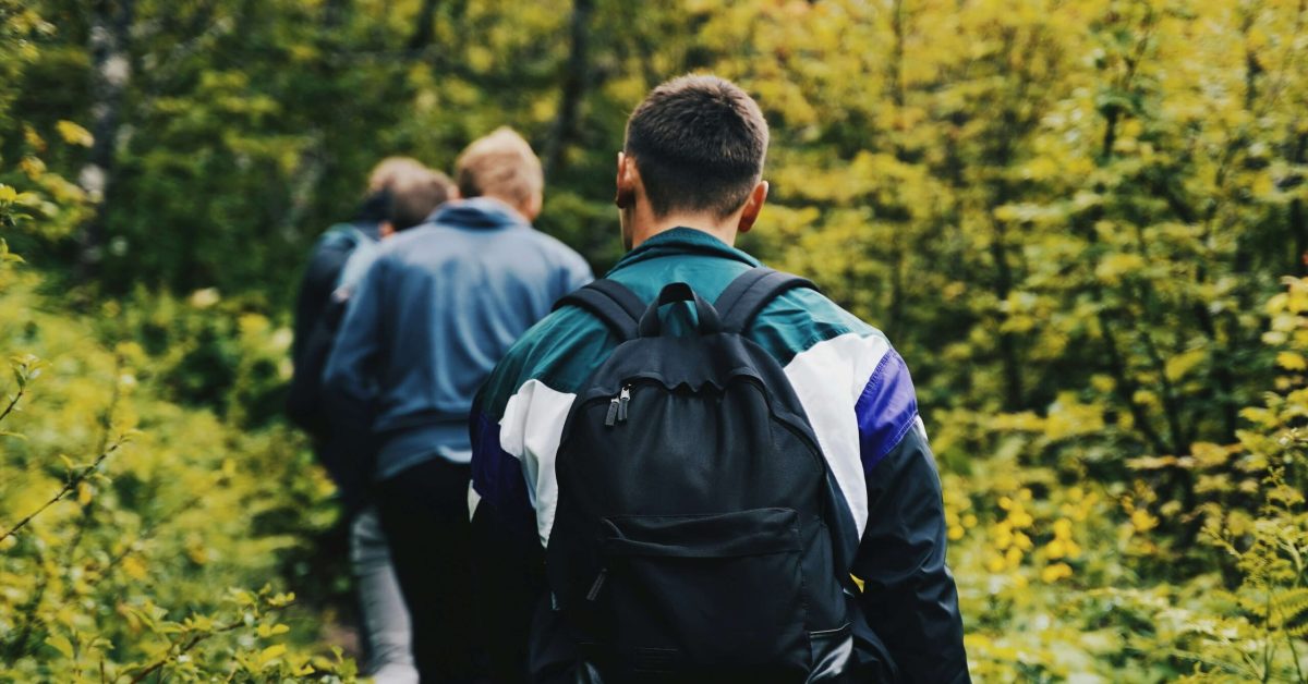 Group of men supporting each other during a Men’s Mental Health Month awareness event outdoors