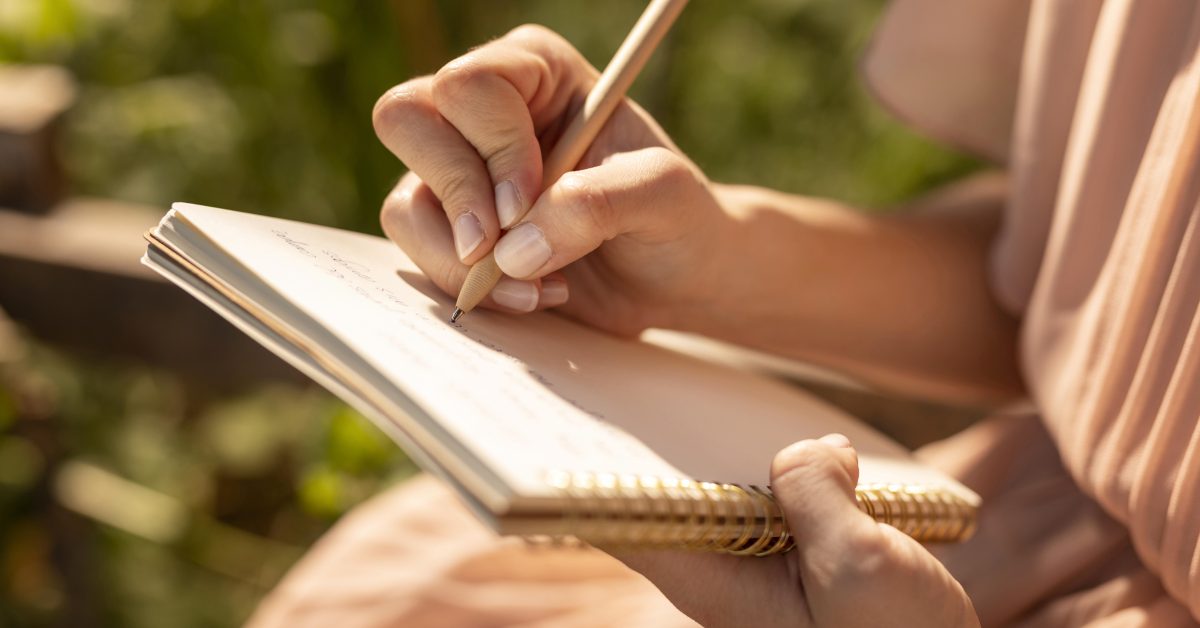 Person writing a relapse prevention plan in a journal