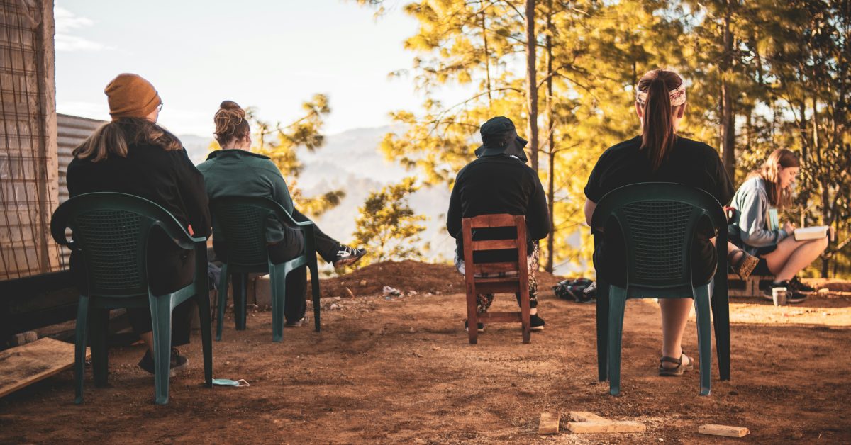 Group therapy session outdoors promoting social wellness month and recovery connections